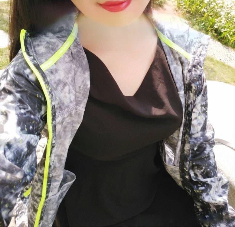 Side view of nylon-covered ankles and toes peeking from heels on a warm outdoor walkway